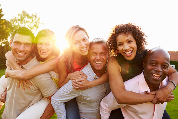 Portrait Of Mature Men Giving Women Piggy Backs Portrait Of Mature Men Giving Women Piggy Backs, Smiling To Camera